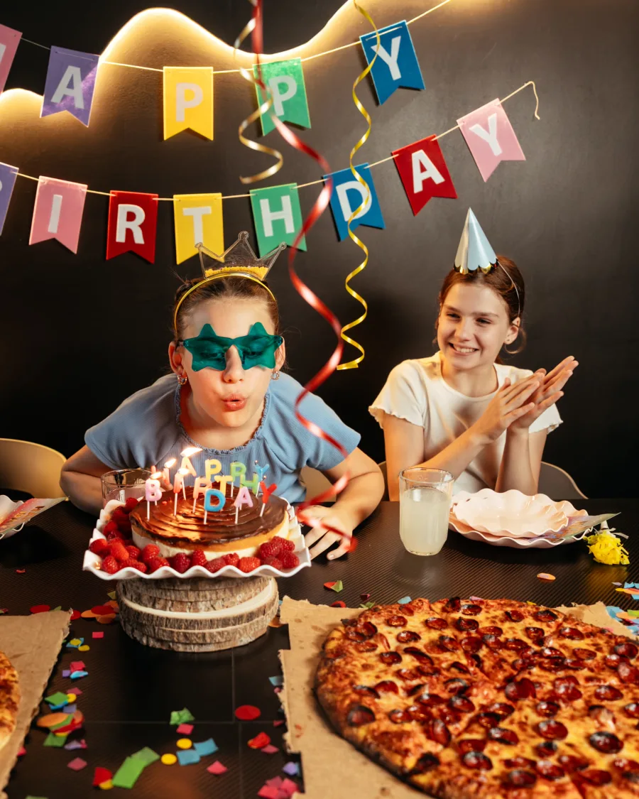A birthday kid blowing out the candles on the cake