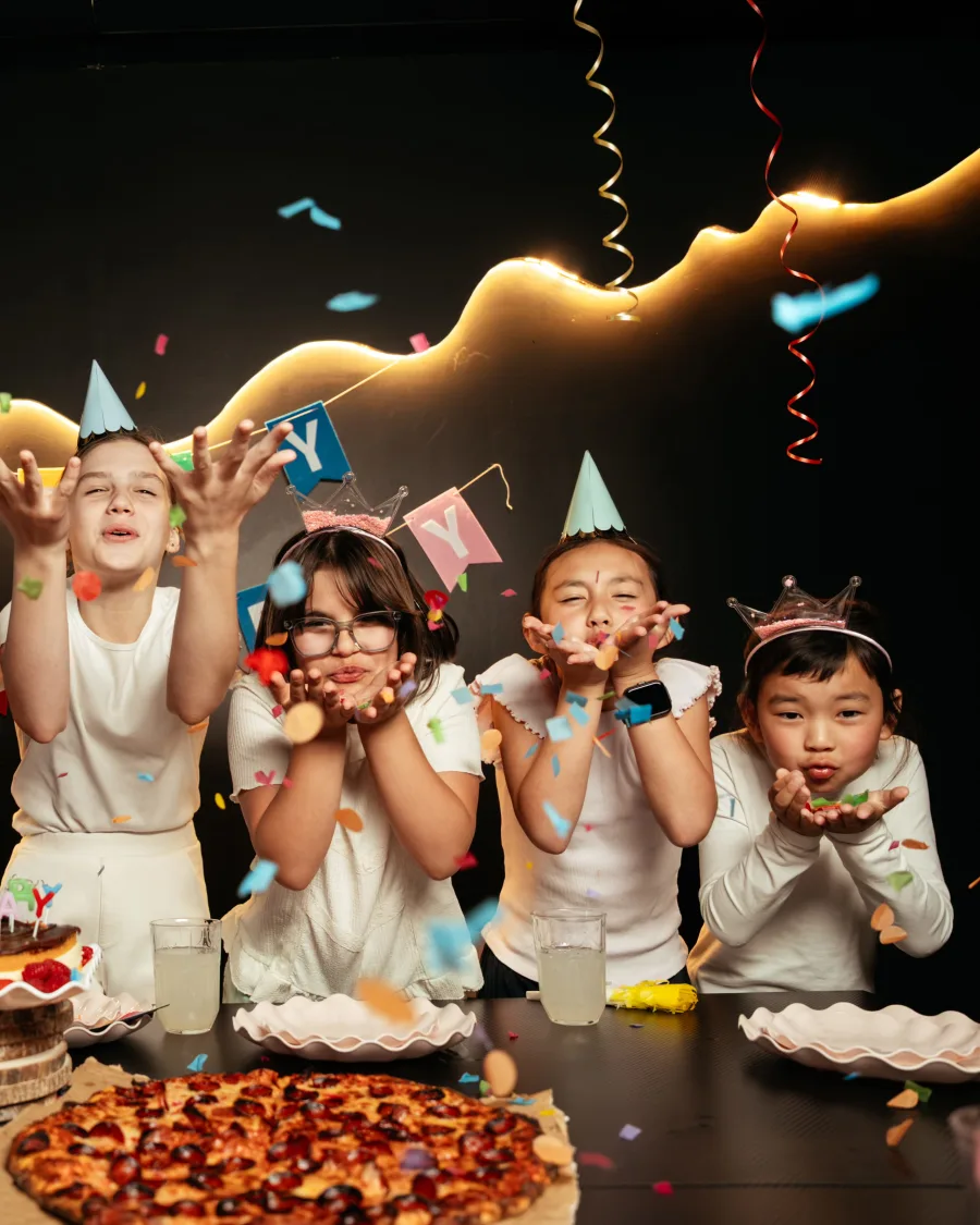 Children in party hats celebrating together at Bond's