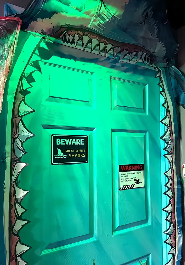 The shark-mouth door at the entrance to Bowl Voyage: Blood Bowl, with its “Beware: Great White Sharks” sign