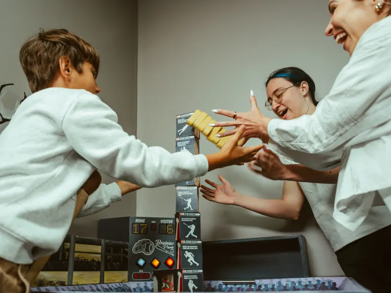 Teammates celebrating a solved puzzle inside a Bond's escape room