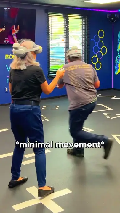 Two parents playing in the VR Arena, with the caption "minimal movement"