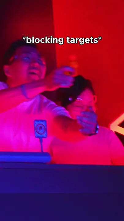 Two players lit in red and blue during a Game Show target challenge